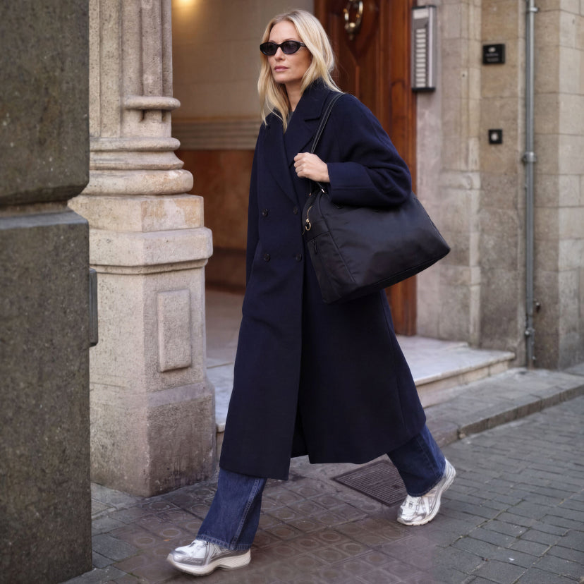 woman carrying the Lo & Sons Trinity laptop tote bag on the way to work