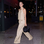 woman walking on sidewalk at night carrying the Aoyama 2 in black/gold