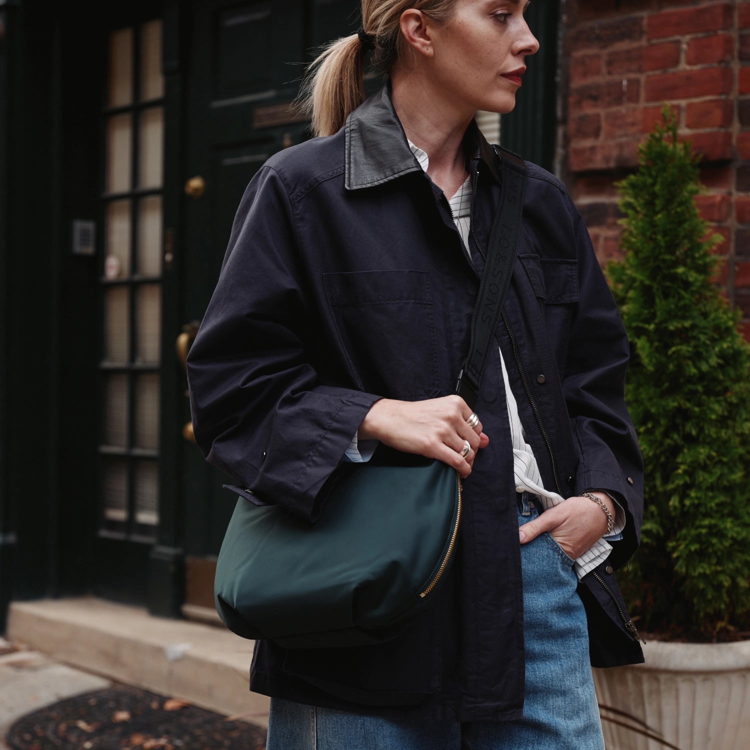 closeup of woman wearing Aoyama in Dark Green as a crossbody bag