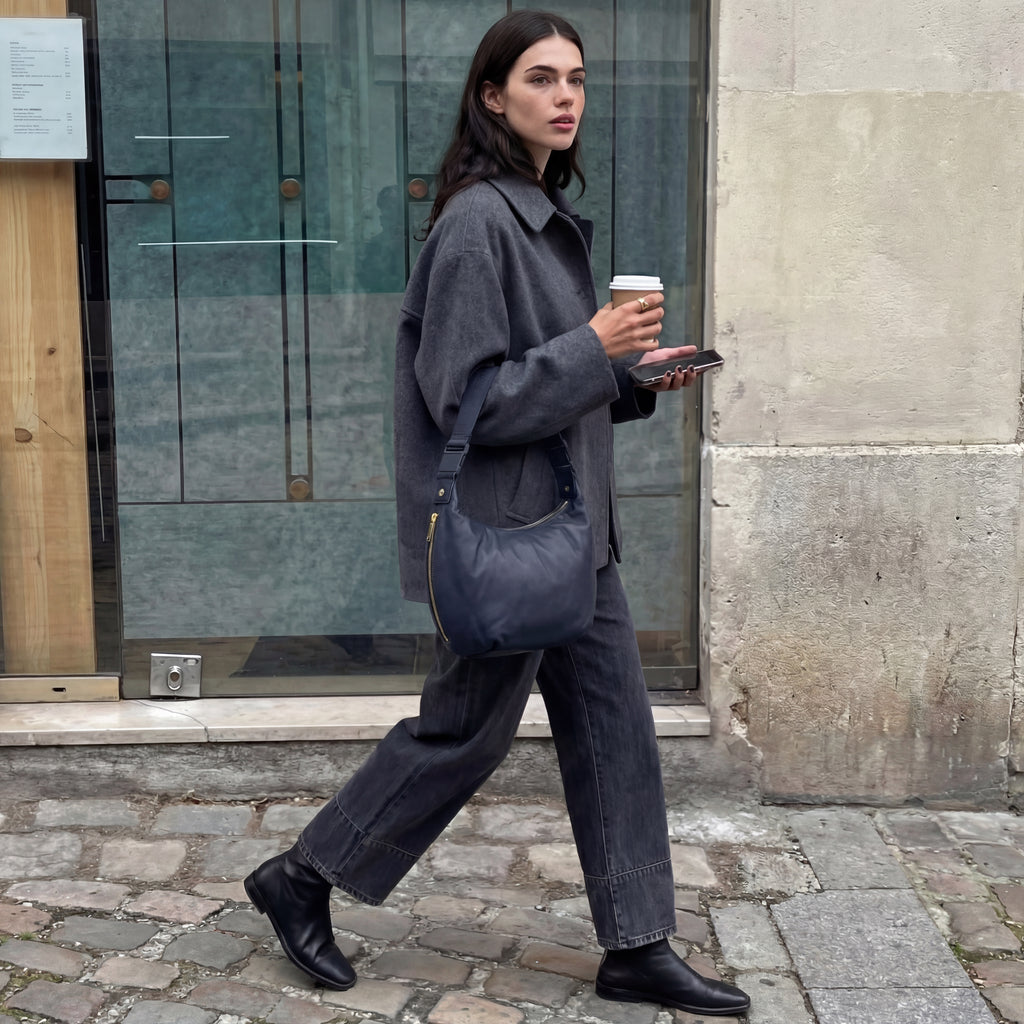 woman walking on sidewalk carrying the Aoyama in Navy Leather