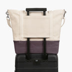 Suitcase handle sleeve of the Catalina Deluxe Tote in thistle colorblock