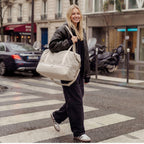 Woman crossing a street with a Catalina Deluxe bag in Dove Grey in an urban setting