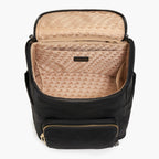 Black Lo & Sons Melrose backpack with open front compartment showing beige interior pattern on a white background