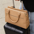 Trinity leather laptop tote sitting on top of suitcase