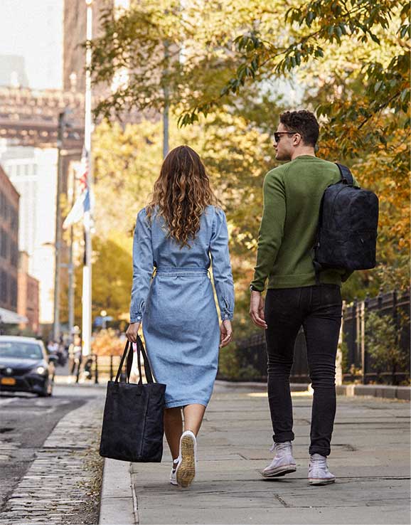 woman and man walking away with camo products