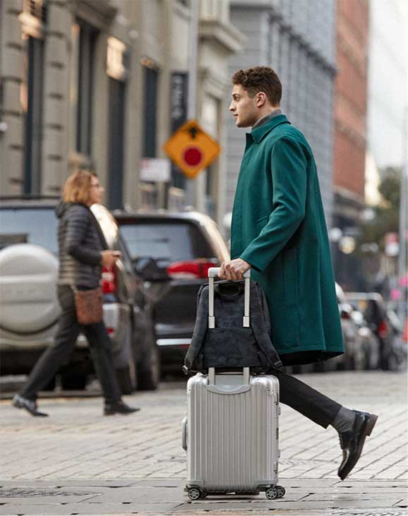 man walking with Hanover on luggage