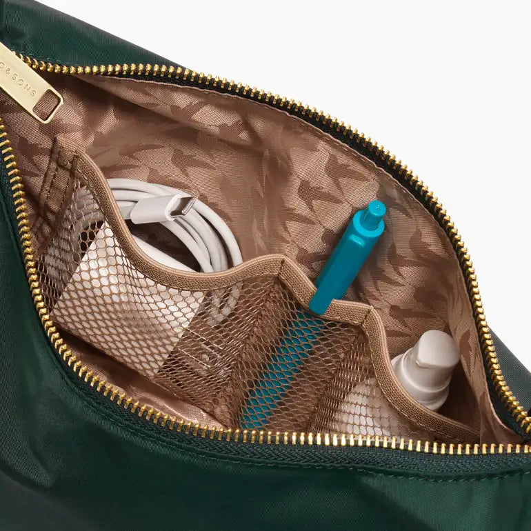 Interior pockets of Lo & Sons Aoyama bag in dark green nylon with gold zipper 