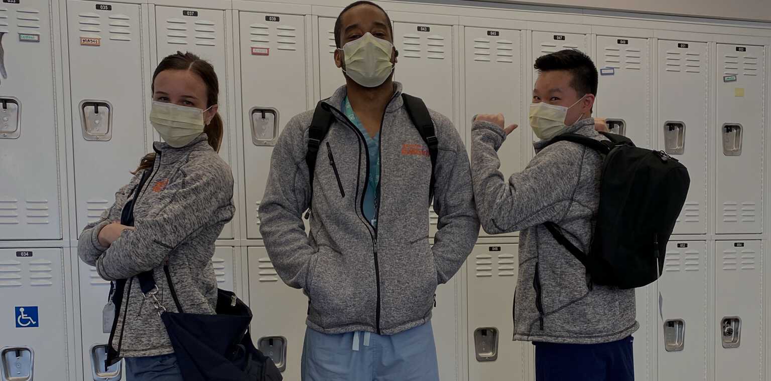 Medical professionals wearing Lo & Sons bags at the hospital during the COVID-19 pandemic