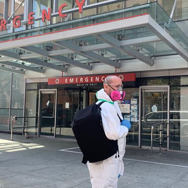 Male medical professional with Lo & Sons Hakuba bag at a hospital during the COVID-19 pandemic