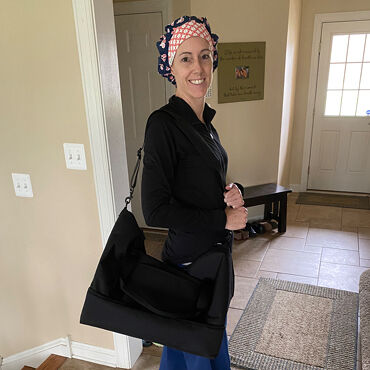 Female medical professional with Lo & Sons Catalina Deluxe bag going to a hospital during the COVID-19 pandemic