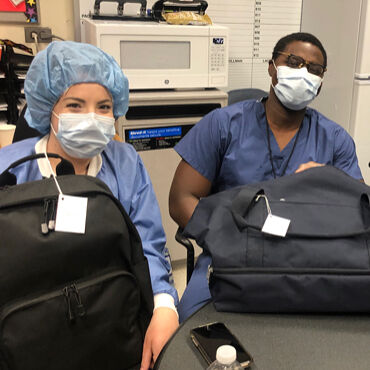 Medical professionals with Lo & Sons bags at a hospital during the COVID-19 pandemic