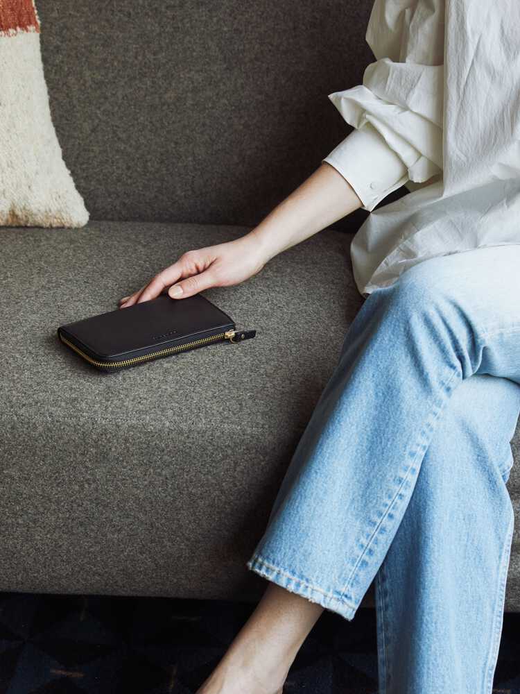 woman sitting on couch with Leather Wallet