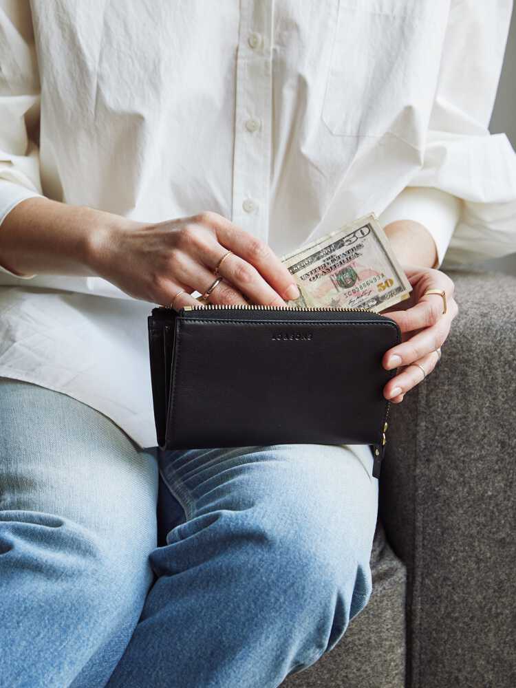 woman putting money in Leather Wallet